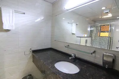 a bathroom with a sink and a mirror at Qaser Al-Sultan Hotel Suites in Amman