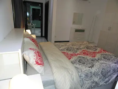 a bedroom with a bed and a couch in it at Diyarkom Apartment in Amman