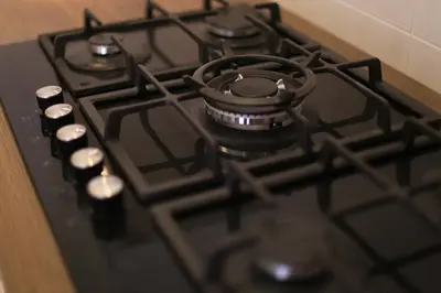 a black stove top oven with a pot on it at Elite Residency in Amman