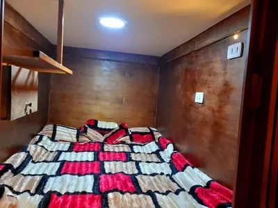 a bedroom with a bed with a colorful blanket on it at Petra Cabin Inn Hostel&Resturant in Wadi Musa