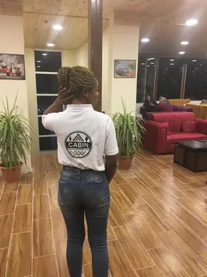 a woman standing in a lobby with her hair in a bun at Petra Cabin Inn Hostel&Resturant in Wadi Musa