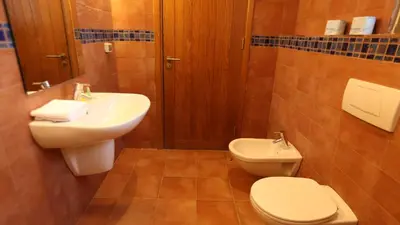 a bathroom with a toilet and a sink at Tala Bay Residence - Families Only in Aqaba