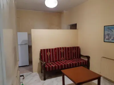 a living room with a couch and a refrigerator at Sami Apartments in Amman