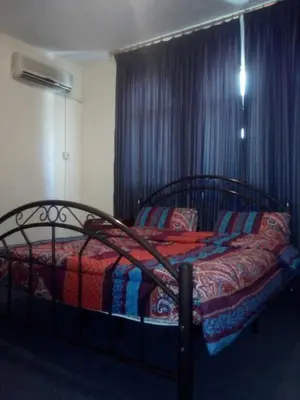a bedroom with a bed with a colorful blanket at Sami Apartments in Amman