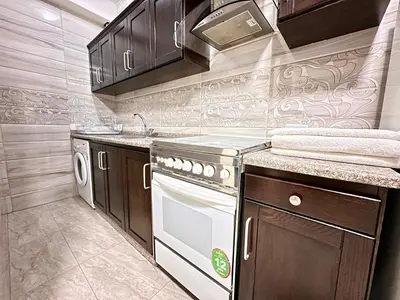 a kitchen with a stove and a dishwasher at Margarita Hotel in Amman