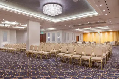 a room with a row of chairs in a hall at Gerasa Hotel in Amman