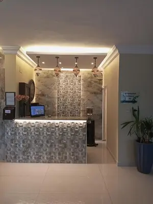 a lobby of a building with a stone wall at Mariam Hotel in Madaba