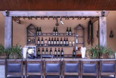 a bar with bottles of wine on the wall at Mariam Hotel in Madaba