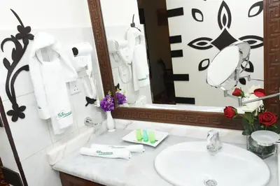 a bathroom with a sink and a mirror at Sparr Hotel in Amman