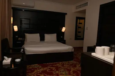 a hotel room with a bed and a sink at Sparr Hotel in Amman