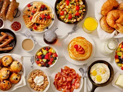 a table full of breakfast foods and drinks at Petra Sella Hotel in Wadi Musa