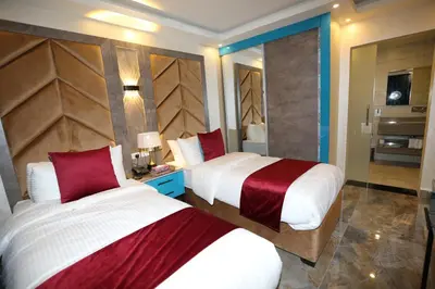 a hotel room with two beds and a bathroom at Petra Sella Hotel in Wadi Musa