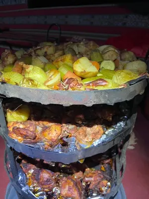 two trays filled with different types of food at Wild of Wadi Rum in Wadi Rum