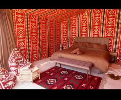 a bedroom with a bed and a rug at Red Mountain Camp in Wadi Rum