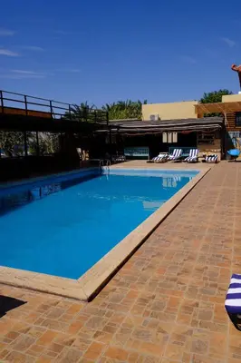 a swimming pool with blue water in a resort at Darna Divers Village in Aqaba