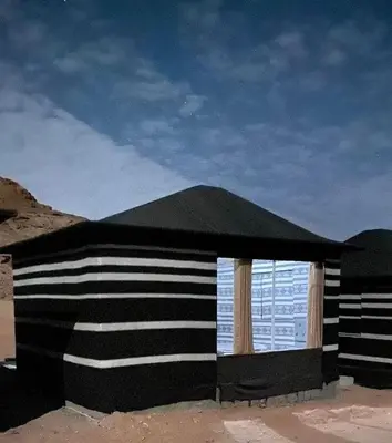 a black and white building with a window at DESERT HELO lUXURY CAMP & TOUR in Wadi Rum