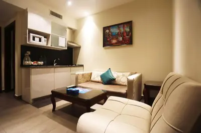 a living room with a couch and a table at Naylover Hotel Suites in Amman