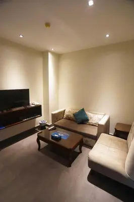 a living room with a couch and a coffee table at Naylover Hotel Suites in Amman