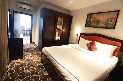 a hotel room with a bed and a window at Naylover Hotel Suites in Amman