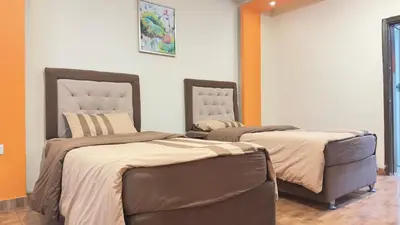 two beds sitting next to each other in a room at Al Riyati Hotel Apartments in Aqaba