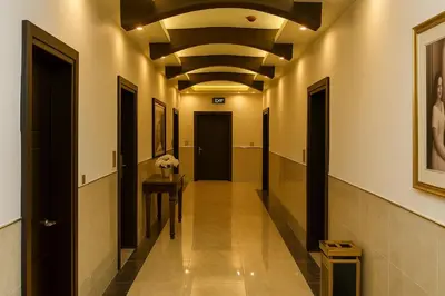 a hallway with a long hallway with a ceiling at Aljamal Hotel in Amman
