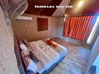 a bedroom with a bed with a stuffed animal on it at Panorama Wadi Rum in Wadi Rum