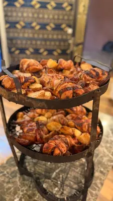 two tiers of pastries and other food on a shelf at Panorama Wadi Rum in Wadi Rum