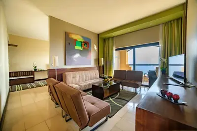 a living room with a couch and a table at Holiday Inn Resort Dead Sea by IHG in Sowayma