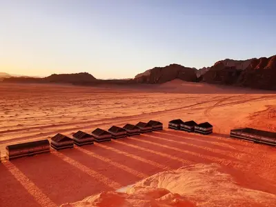 a group of train cars in the desert at Wadi Rum Desert Camp in Wadi Rum