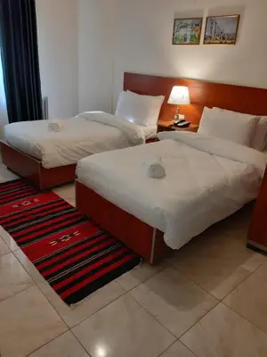 two beds in a hotel room with at New Park Hotel in Amman