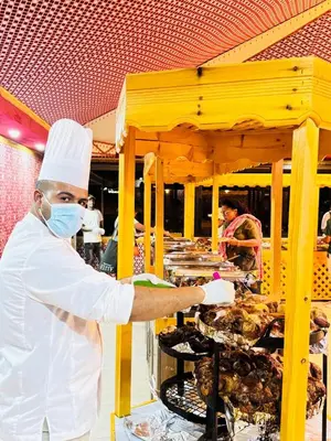 a chef is preparing food on a table at Beauty Wadi Rum Luxury Camp in Wadi Rum