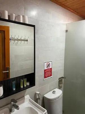 a bathroom with a white toilet and a mirror at Beauty Wadi Rum Luxury Camp in Wadi Rum