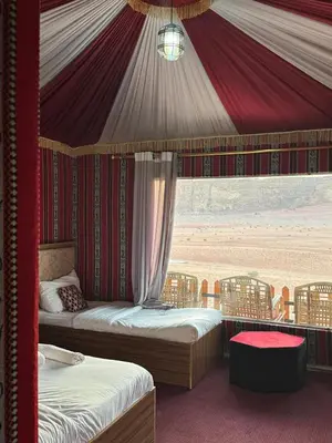 a bedroom with two beds in a tent at Beauty Wadi Rum Luxury Camp in Wadi Rum