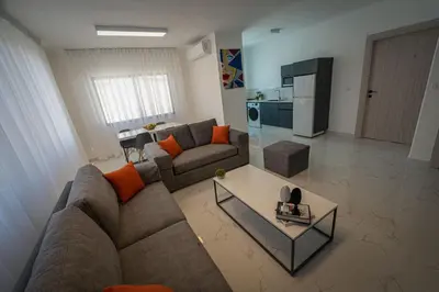 a living room with a couch and a table at Al Kawther Hotel Apartments in Amman
