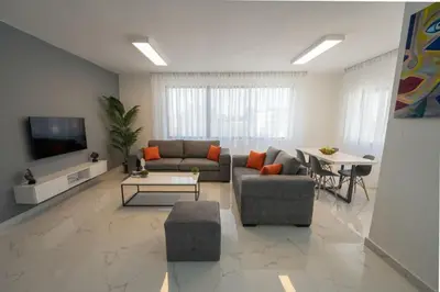 a living room with a couch and a table at Al Kawther Hotel Apartments in Amman