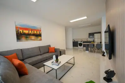 a living room with a couch and a table at Al Kawther Hotel Apartments in Amman
