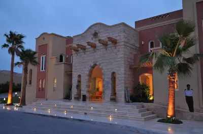 a man standing in front of a building at Marina Plaza Hotel, Tala Bay in Aqaba