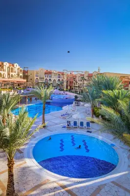 an overhead view of a resort pool with palm trees and buildings at Marina Plaza Hotel, Tala Bay in Aqaba