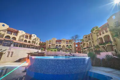 a pool of water in a courtyard with buildings at Marina Plaza Hotel, Tala Bay in Aqaba