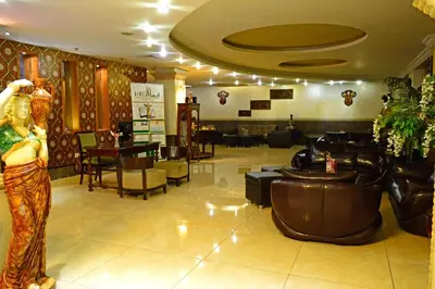 a lobby with a woman standing in front of a salon at Larsa Hotel in Amman