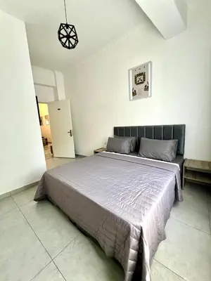 a bedroom with a large bed in a room at Jordan Tower Hotel in Amman