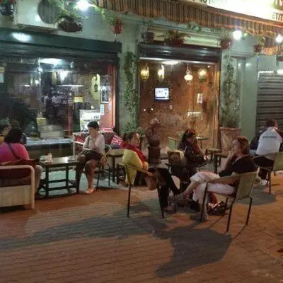 a group of people sitting in chairs in a restaurant at Jordan Tower Hotel in Amman
