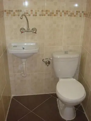 a bathroom with a toilet and a sink at Jordan Tower Hotel in Amman
