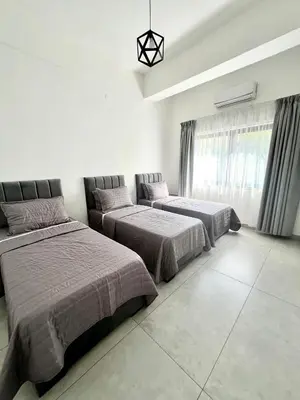a bedroom with two beds and a window at Jordan Tower Hotel in Amman