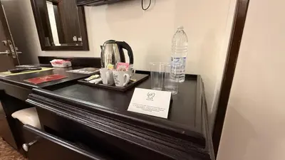 a black counter with a bottle of water on it at Rojina Hotel in Amman