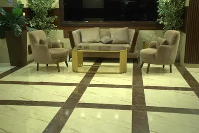 a living room with a couch and two chairs at Rojina Hotel in Amman