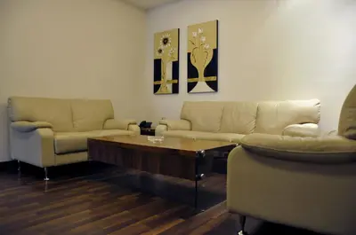 a living room with two couches and a coffee table at Granada Suites Hotel in Amman