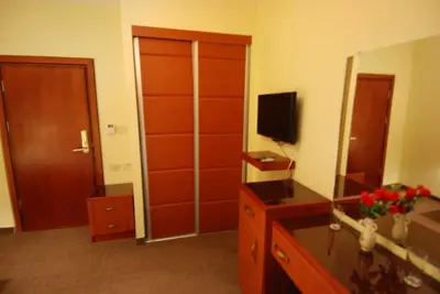 a room with a large closet with a television on it at Al Rashid Hotel in Wadi Musa