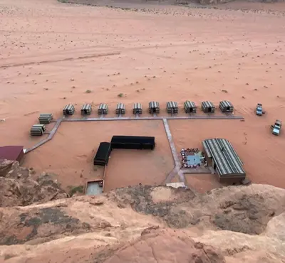 an aerial view of a parking lot in the desert at Wadi Rum Jordan Camp in Wadi Rum