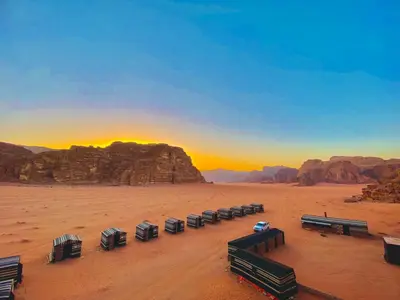 a group of benches in the desert at sunset at Wadi Rum Jordan Camp in Wadi Rum